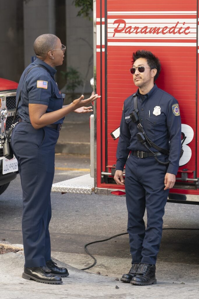 Hen and Chimney chat in the field during 9-1-1 Season 8 Episode 4.