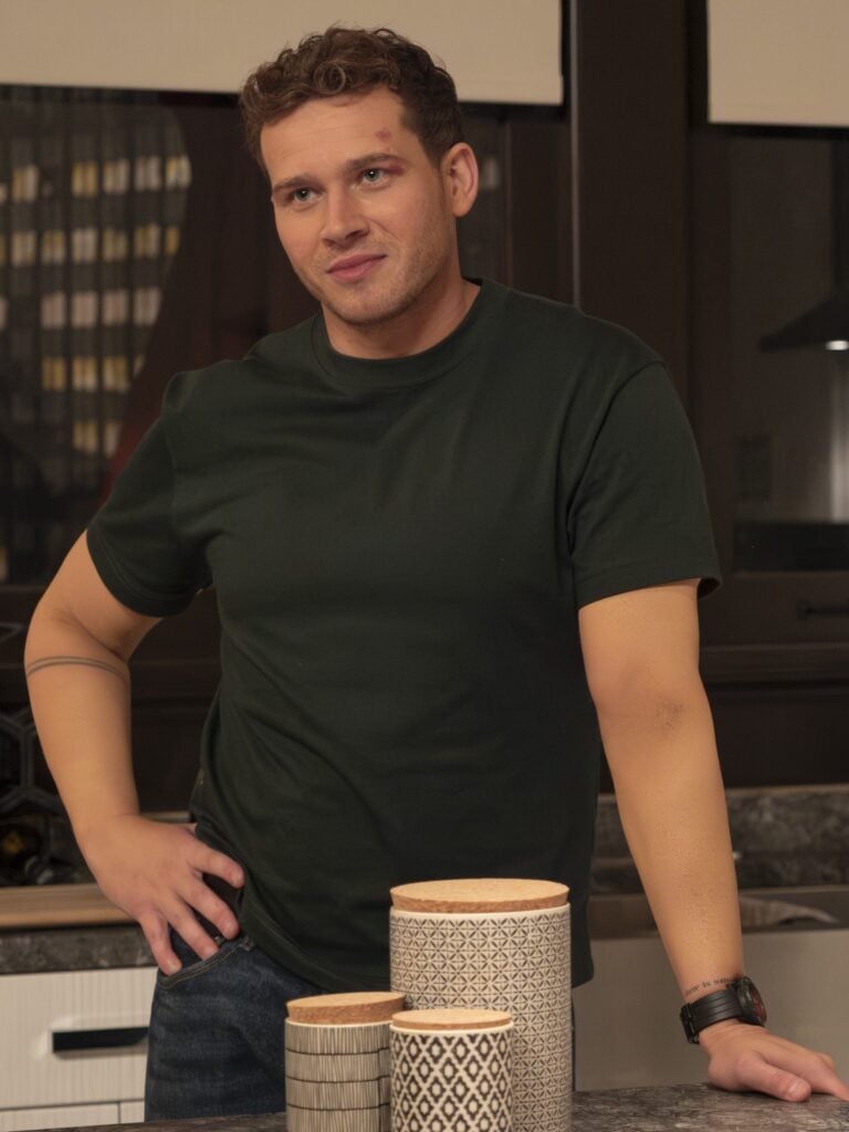 Buck strikes a pose in the kitchen during 9-1-1 Season 8 Episode 6.