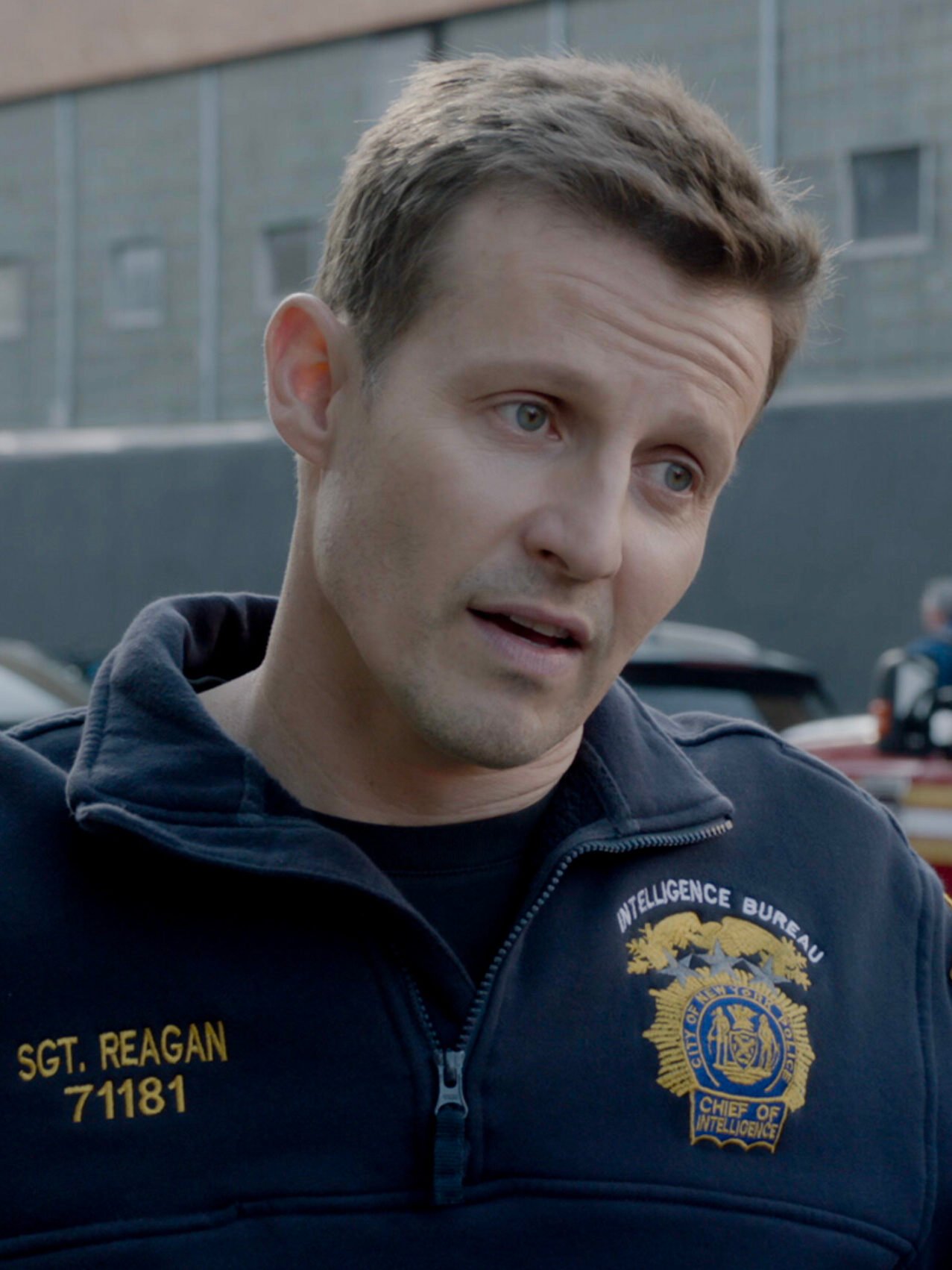 Jamie talking to Eddie in the parking lot of the police precinct on Blue Bloods Season 14 Episode 15