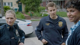 Eddie and Jamie standing outside Badillo's house talking to his mother on Blue Bloods Season 14 Episode 15