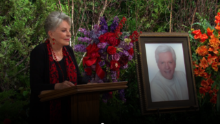 Julie stands behind the podium in the garden where Doug's funeral is being held on Days of Our Lives