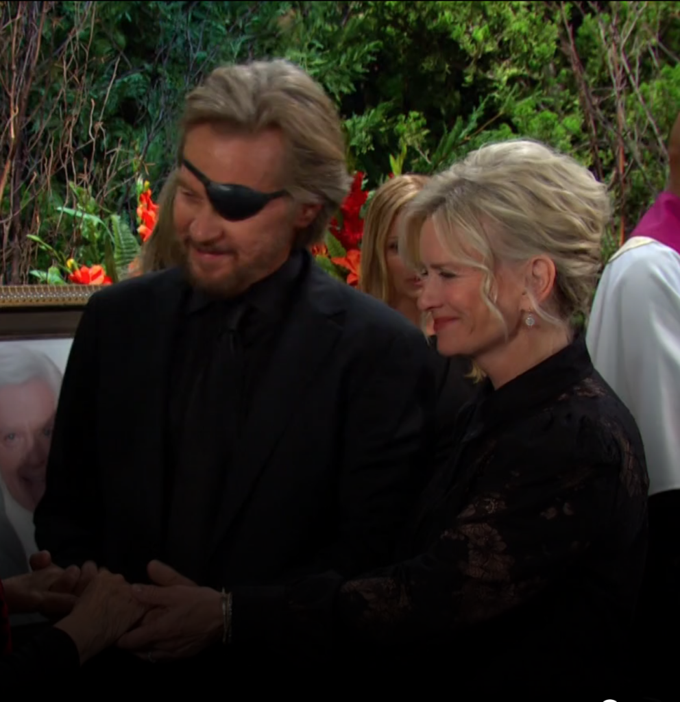 Steve and Kayla standing together at Doug's memorial on Days of Our Lives